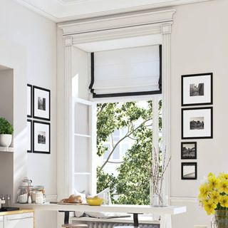 Black and white roman shades in contemporary kitchen with classic wall art
