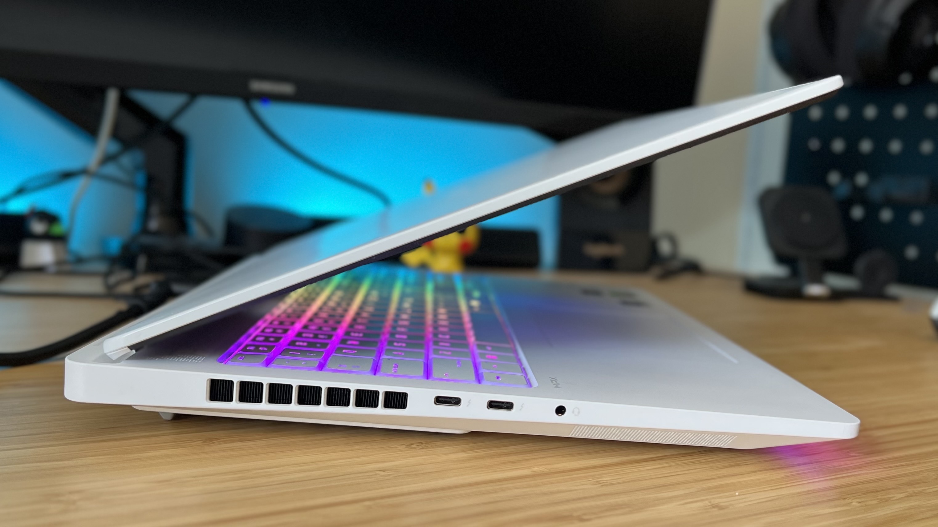 Side view of HP Omen Max 16 gaming laptop on a wooden desk 