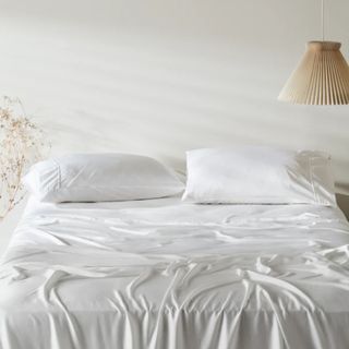 Ettitude Signature Sateen Sheet Set in white on bed with lampshade in shot