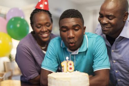A son celebrating his 18th birthday with his parents