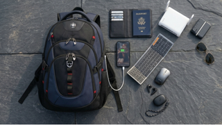 A selection of business travel tech on a stone background