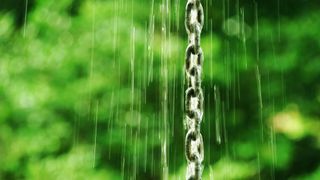A rain chain with rain flowing down it