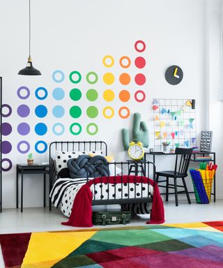 Rainbow colored rugs in kids bedroom