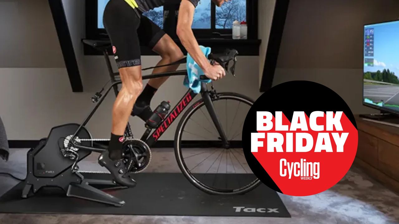 The Tacx Flux S Smart Trainer being riden by a white man with a Black Friday Cycling Weekly roundal on the image