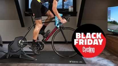 The Tacx Flux S Smart Trainer being riden by a white man with a Black Friday Cycling Weekly roundal on the image
