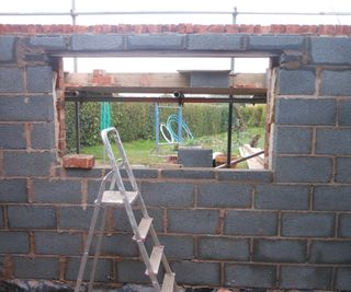 breeze block wall with opening for new window