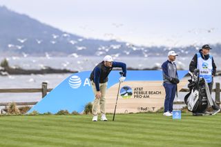 Scottie Scheffler watches his tee shot at the final hole at Pebble Beach