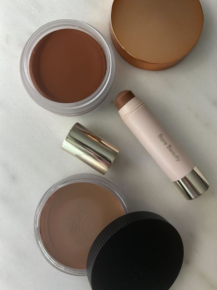A selection of cream bronzers on a marble table