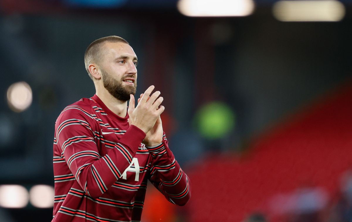 Liverpool defender Nat Phillips applauds the fans during the warm-up