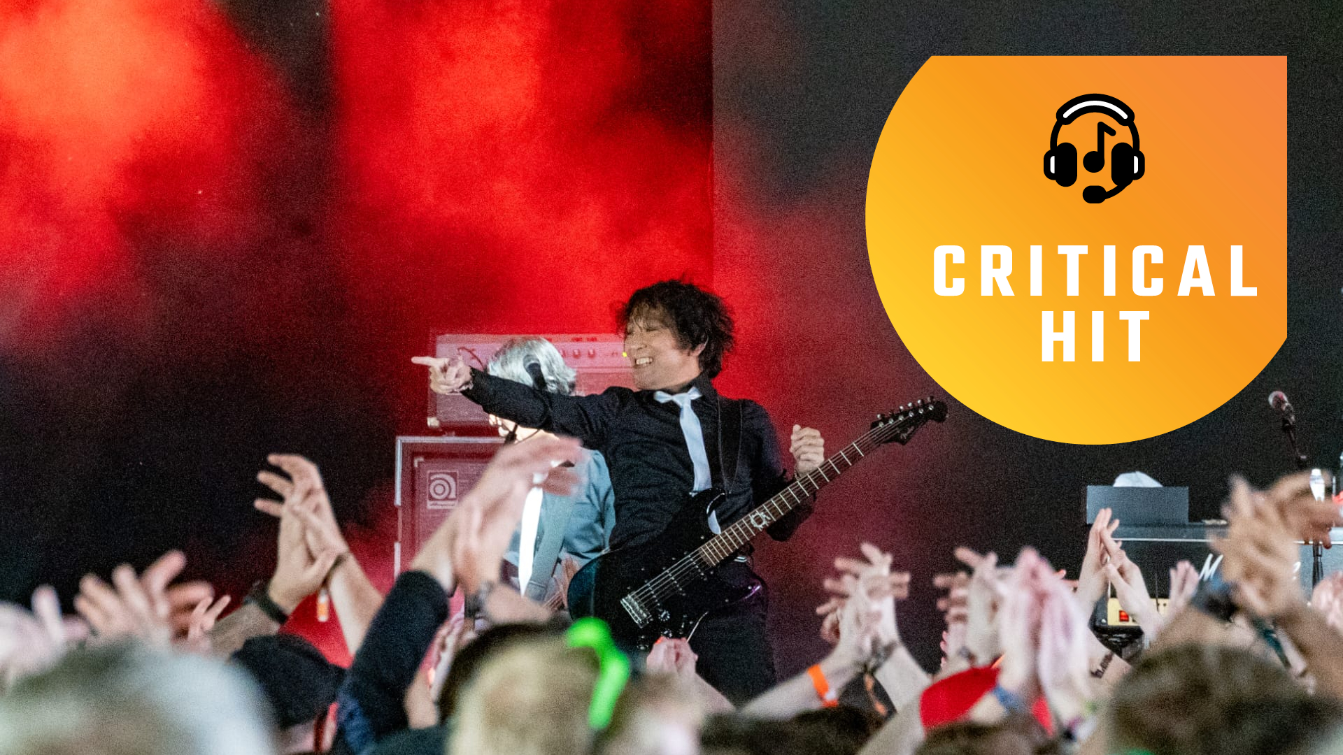 The Primals at Download Festival. Final Fantasy 14 composer Masayoshi Soken points towards the crowd as he smiles.