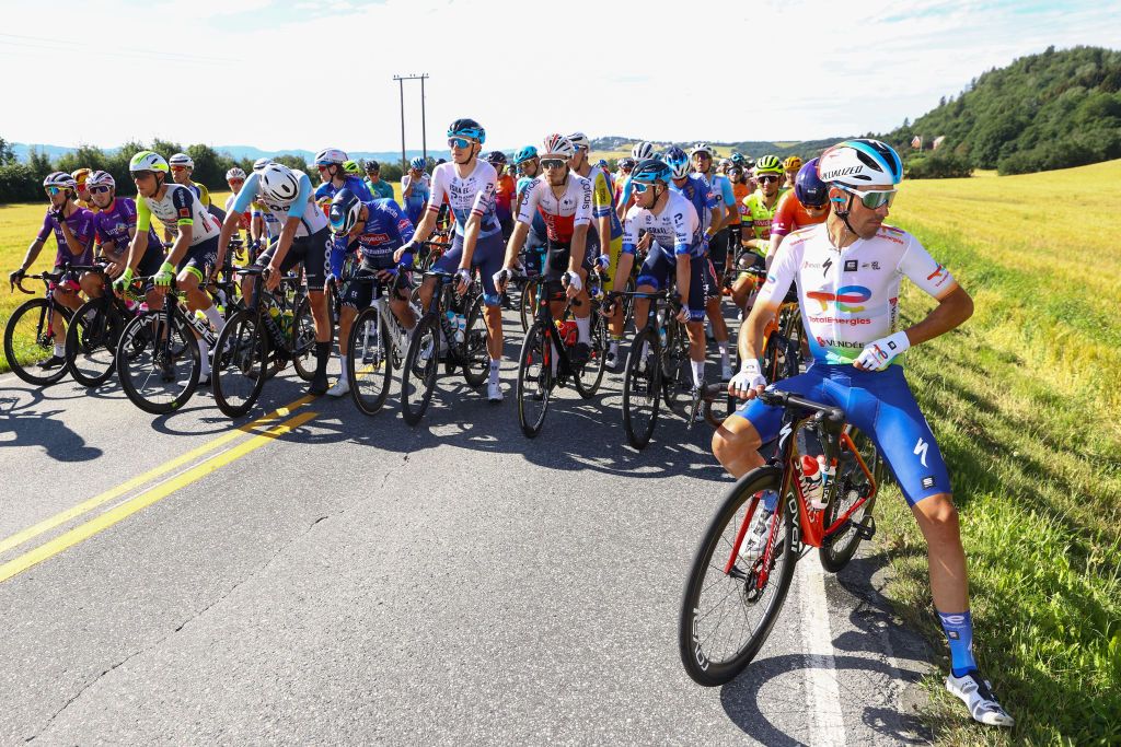 TRONDHEIM NORWAY AUGUST 14 LR Krists Neilands of Latvia and Team Israel Premier Tech Andr Rodrigues De Carvalho of Portugal and Team Cofidis Simon Clarke of Australia and Team Israel Premier Tech Victor De La Parte Gonzalez of Spain and Team Total Energies and the peloton stopped by a group of protesters blocking the race during the 9th Arctic Race Of Norway 2022 Stage 4 a 1591km stage from Trondheim to Trondheim ArcticRace on August 14 2022 in Trondheim Norway Photo by Michael SteeleGetty Images
