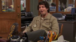 Andy Samberg putting his feet up on the desk on Parks and Recreation.