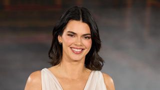 Kendall Jenner smiling while walking the carpet for L'Oréal Paris Womenswear Spring/Summer 2026 show