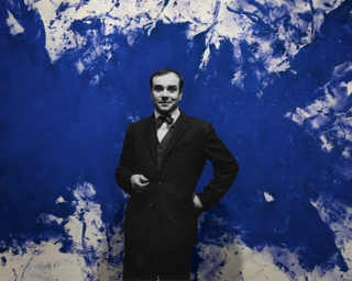 Artist Yves Klein in front of the work "Grande Anthropophagie bleue,