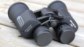 Image shows the lens caps on the Celestron UpClose G2 10x50 binoculars.