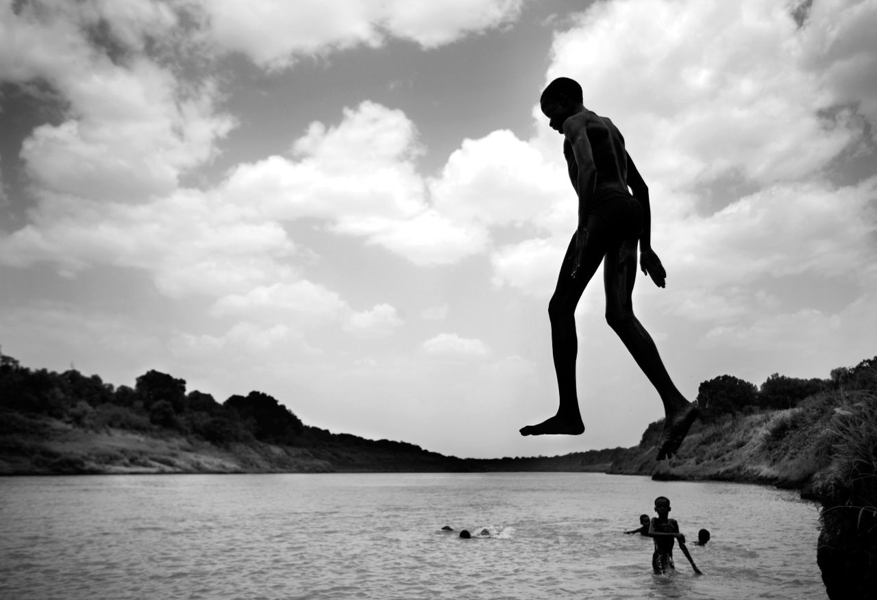 A man jumping into a river.