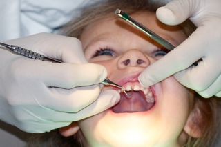 young girl gets dental examination