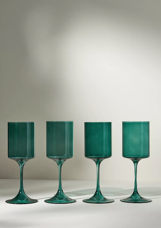 four green wine glasses in a row