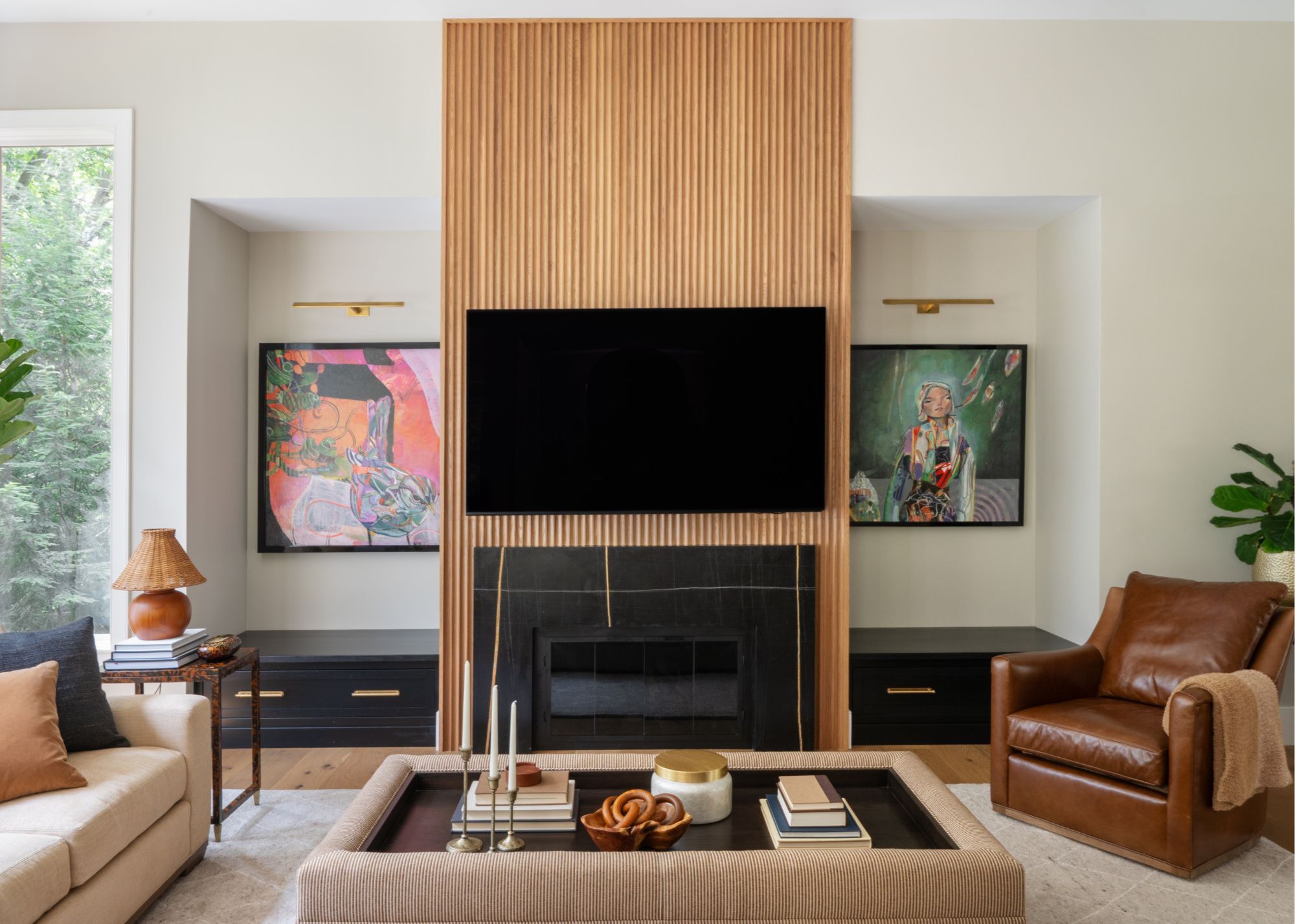 A living room with a fluted, wooden TV unit with a fireplace