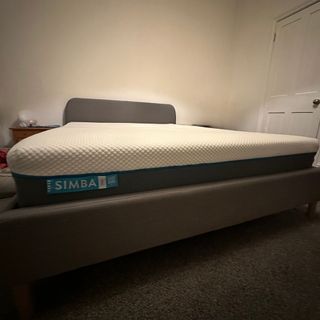 The Simba Hybrid Pro mattress in a bedroom with a carpeted floor