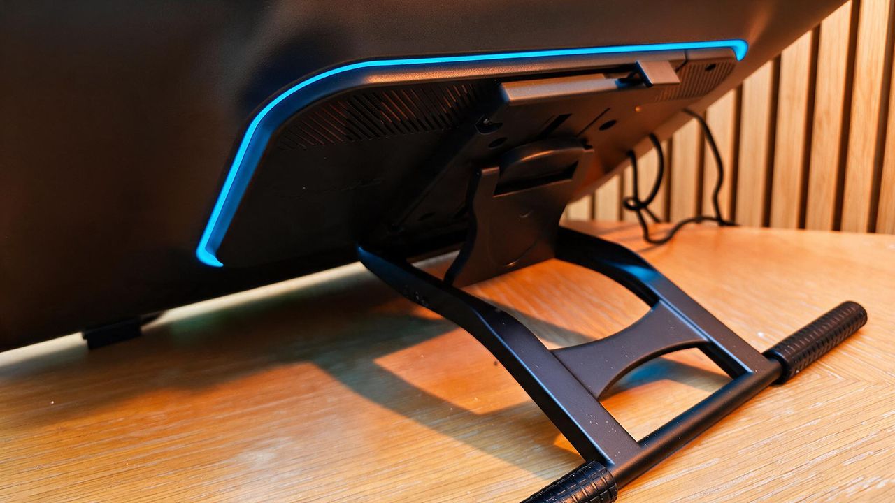 A black drawing tablet on a wooden desk