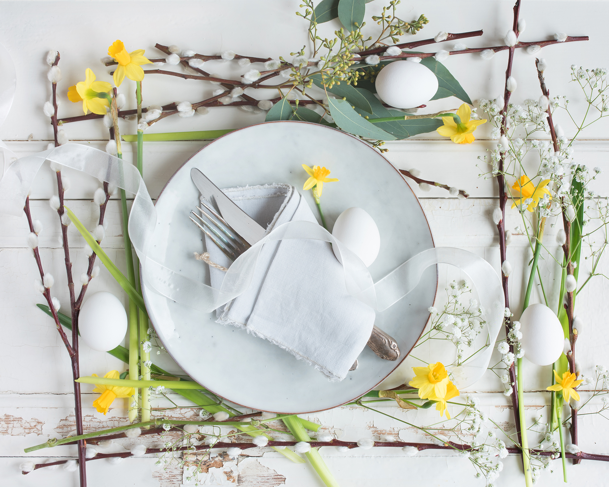 Easter place setting with pussy willow stems and spring flowers