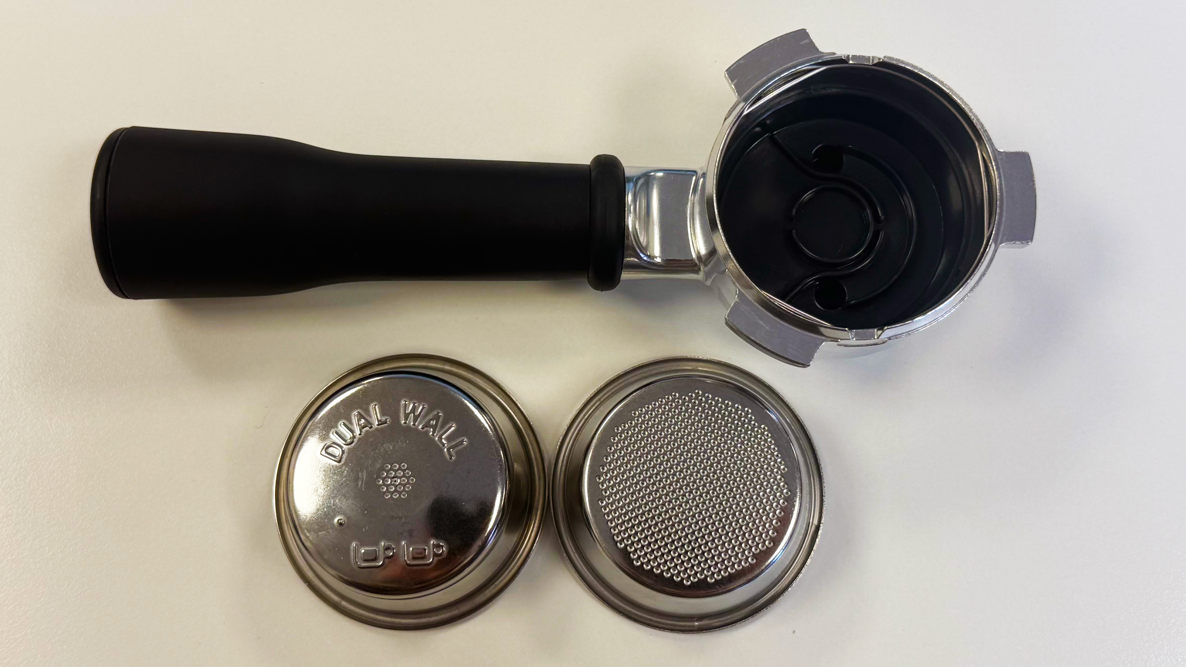 a disassembled portafilter and portafilter basket