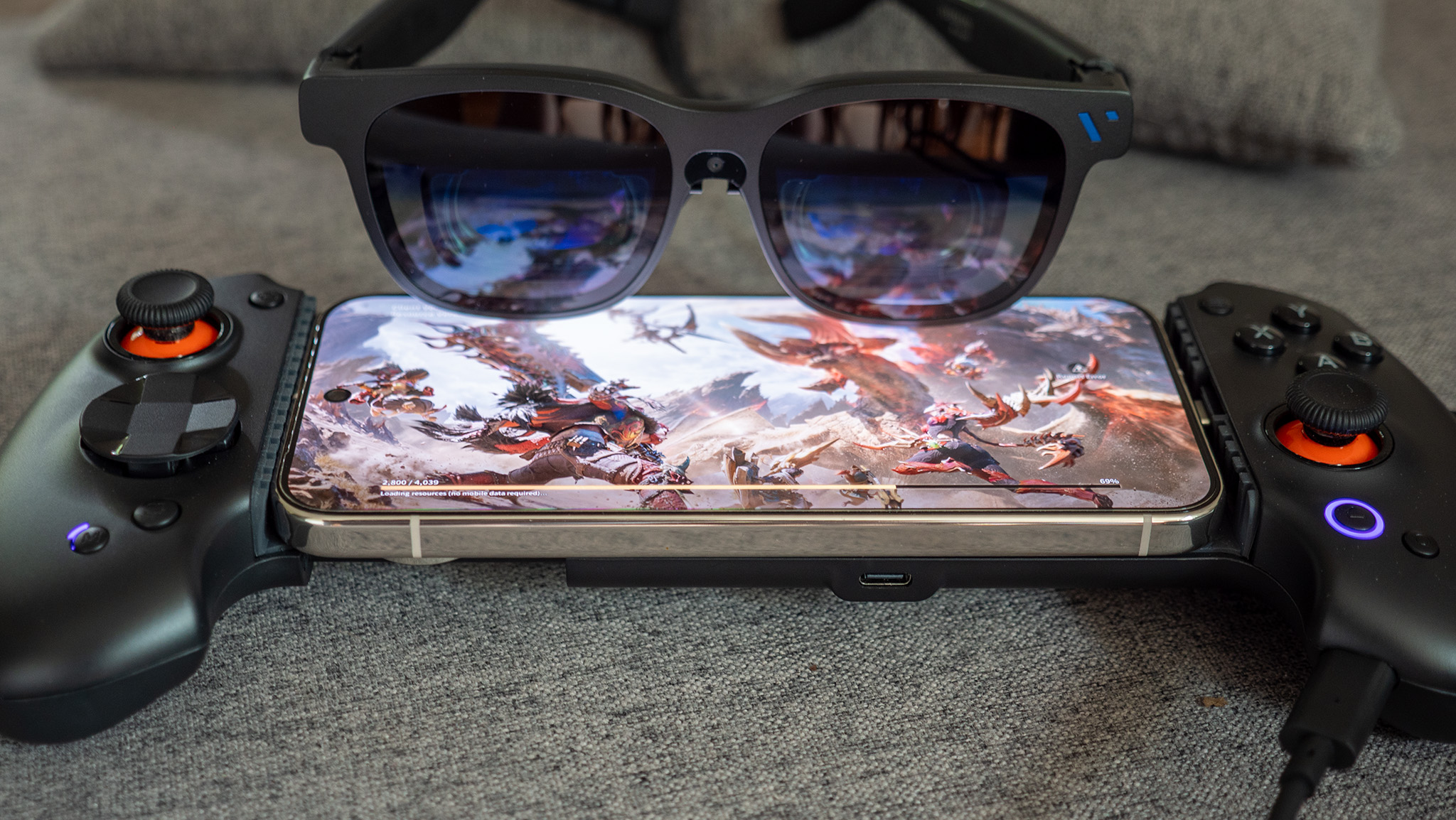 Viture Beast smart glasses connected to an Abxylute S9V controller, with Monster Hunter Outlanders playing on a Google Pixel 10 Pro XL