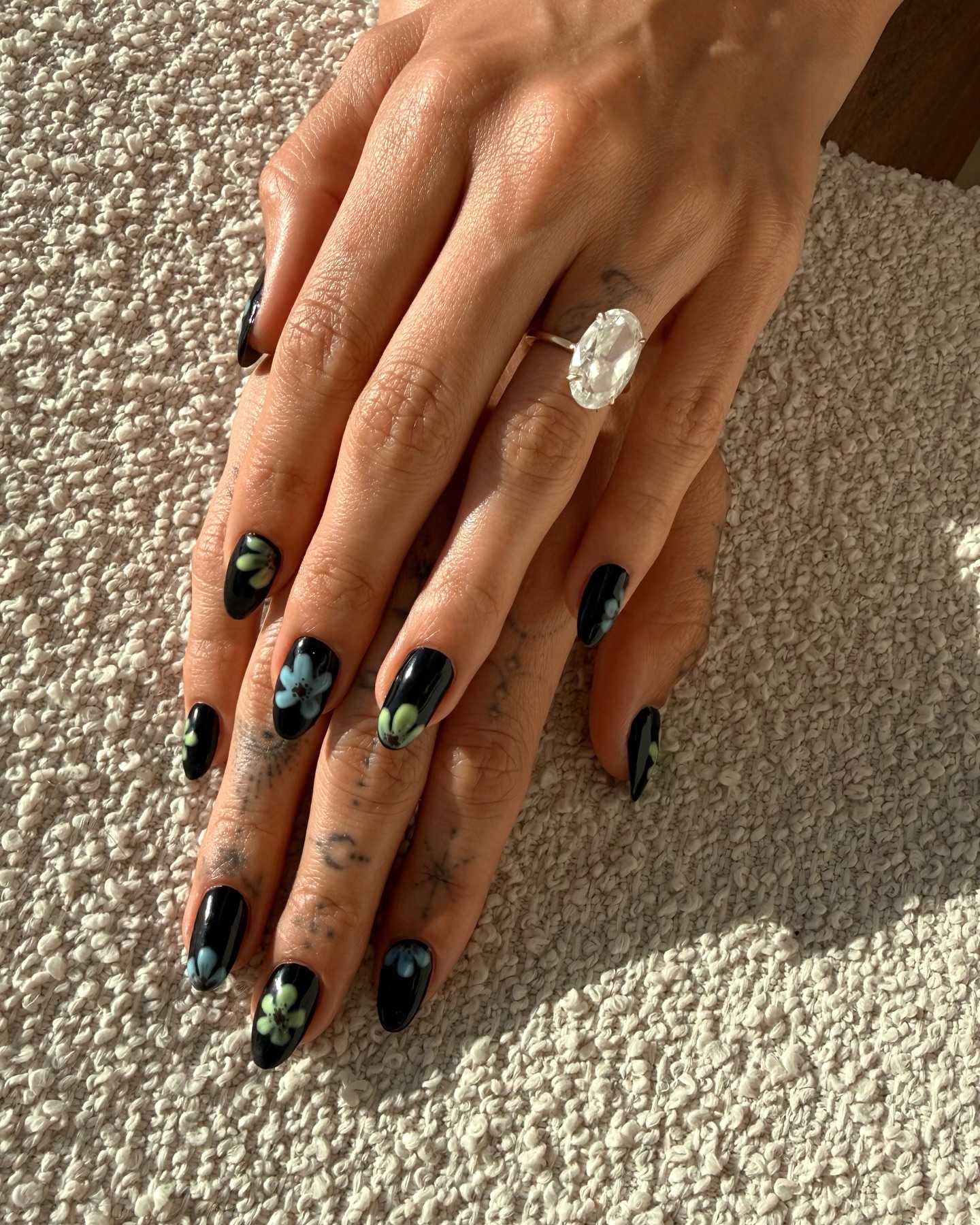Hailey Bieber's black floral nails at Coachella 2026.