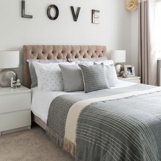 bedroom with white wall and grey bedlinen