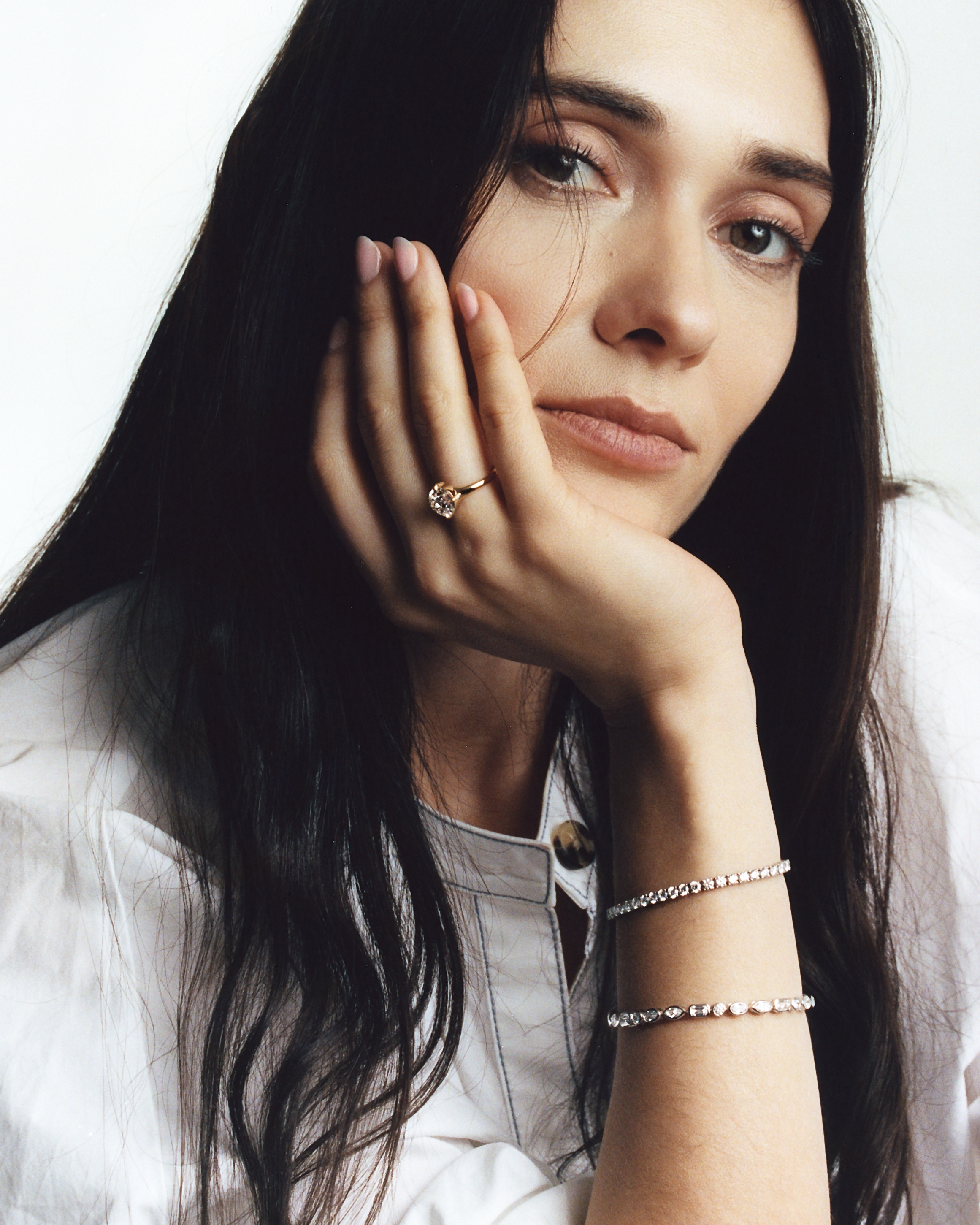 Woman wears Steph Mazuera diamond tennis bracelet.