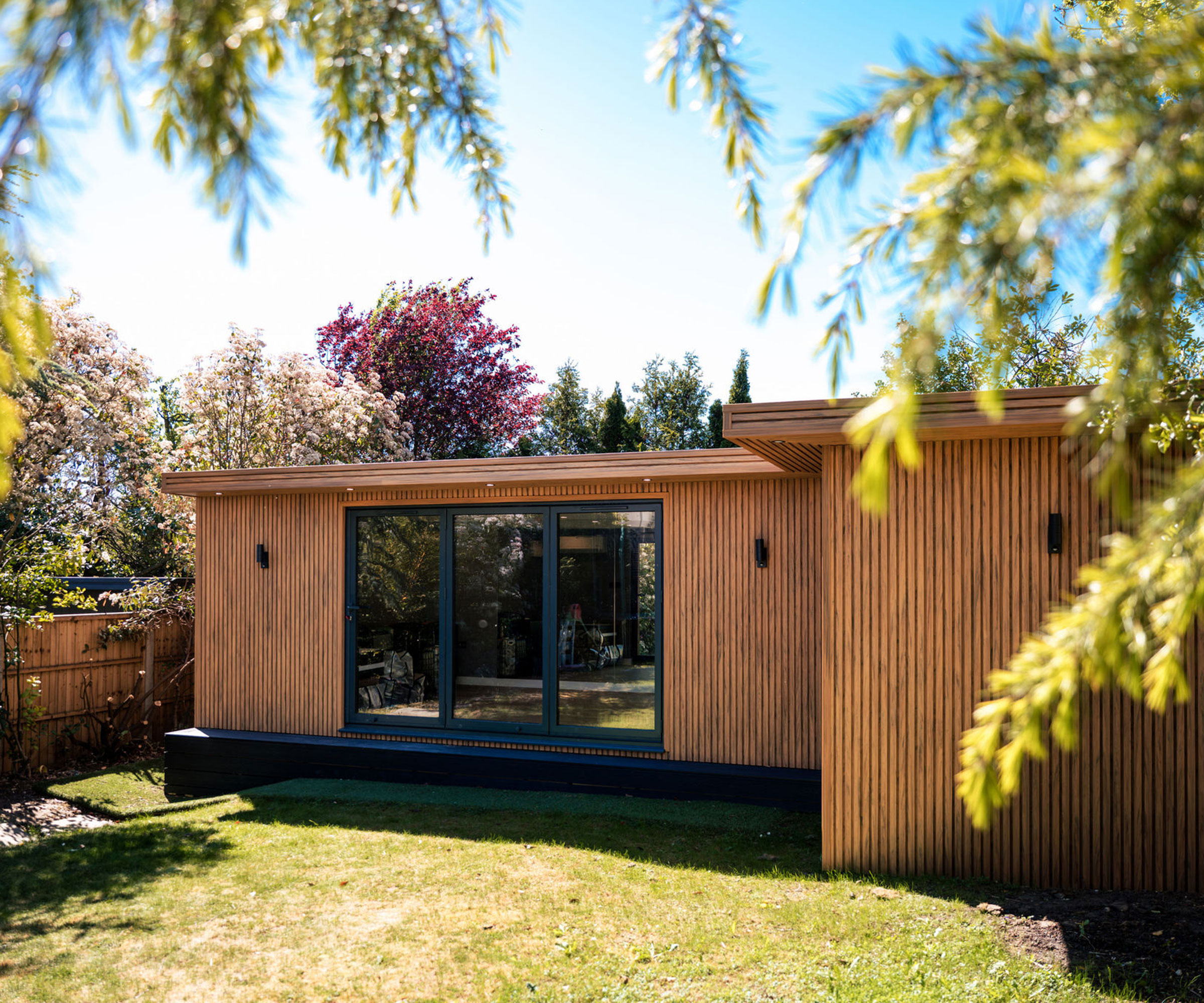 timber-clad garden room annexe in a large rear garden