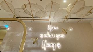 Sign reading 'Home is where the Honey is' on the wall of Hive