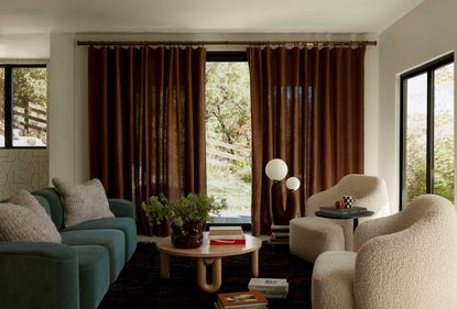 a living room with rust color curtains