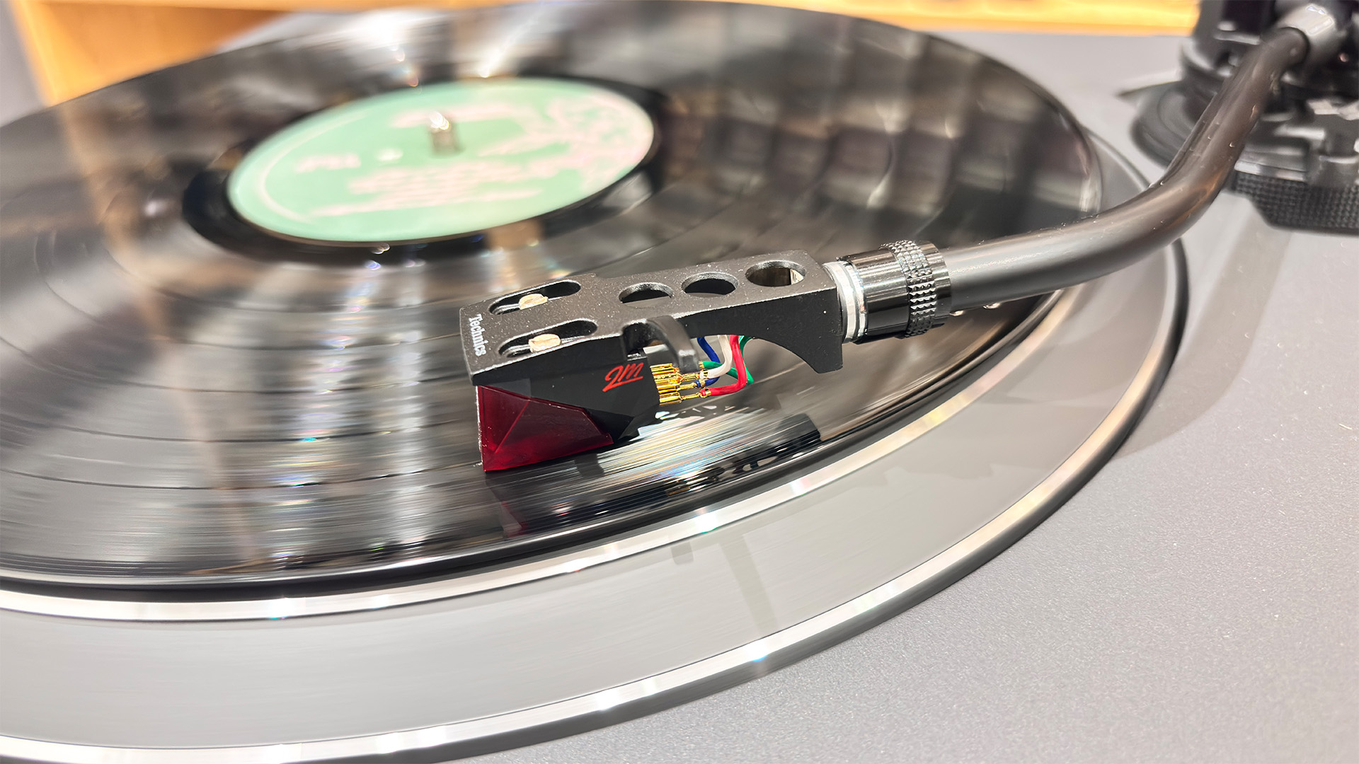 Technics SL-1500CS turntable close up on tonearm and headshell on vinyl record