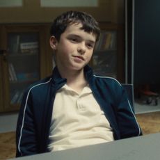 owen cooper in the interrogation room in a still from adolescence