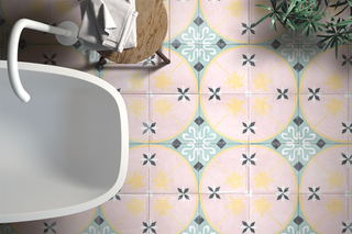 Prettily patterned encaustic Spanish tiles on the floor of a small bathroom