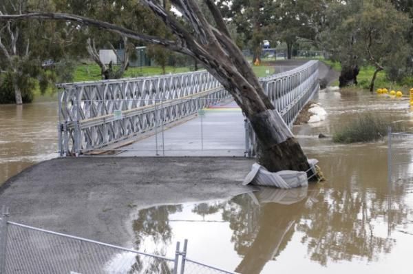 Water sat on top of the road built to connect the bridge to the course, while a tree had also shifted due to the flooding.