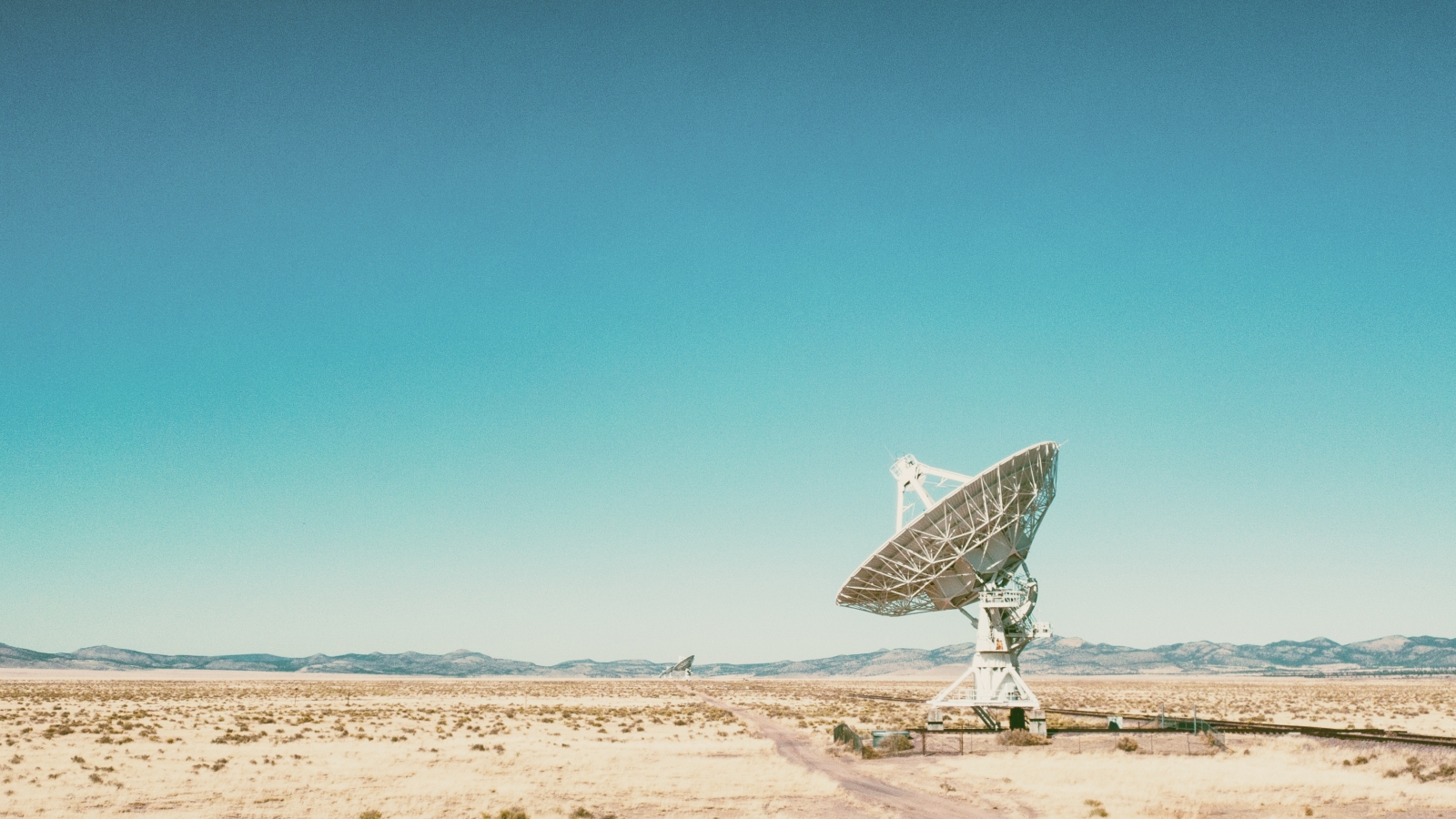 A photo of a radio telescope dish in the New Mexico desert