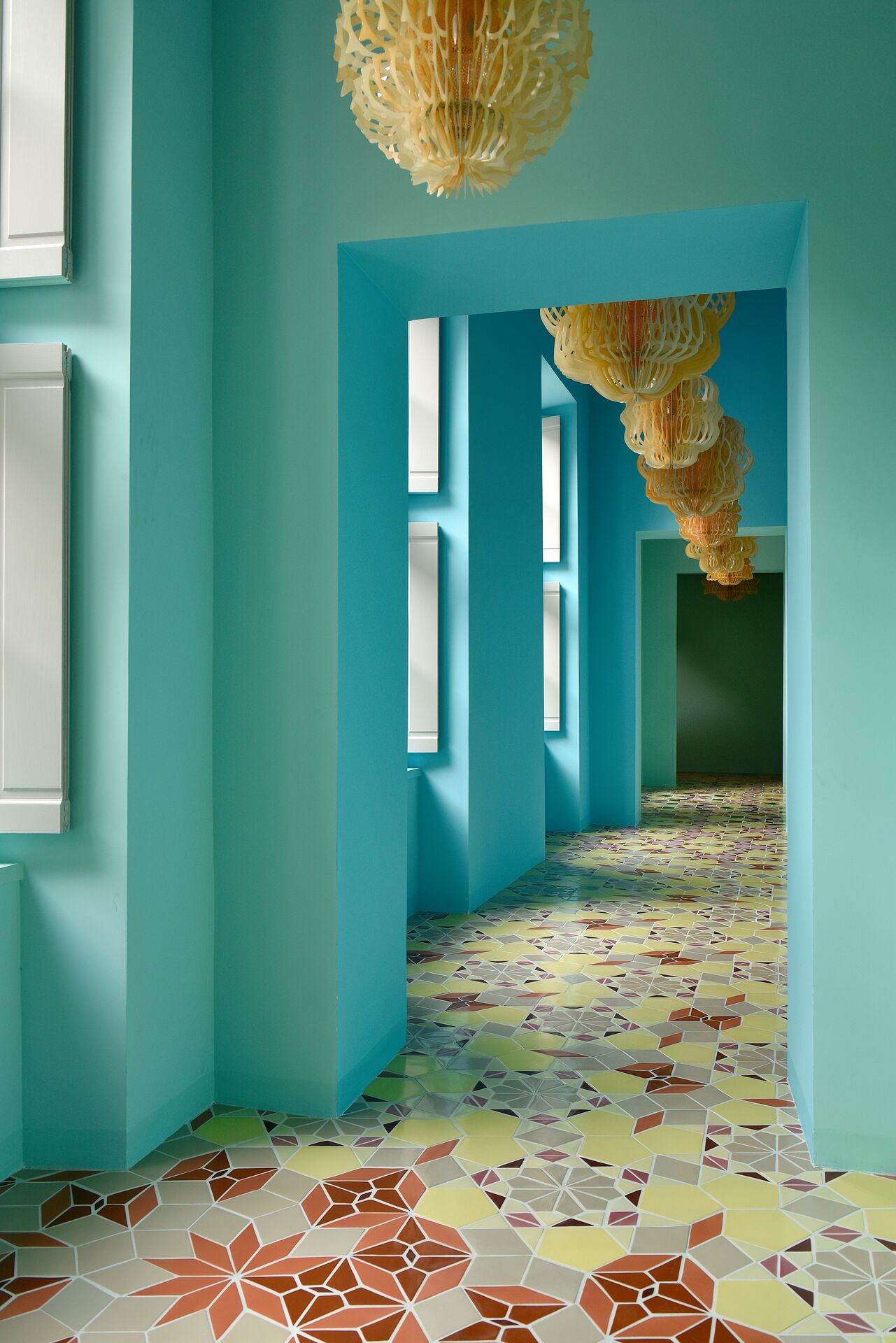 A textiles, tiles, and rattan-clad hotel boasts a kaleidoscopic atmosphere defined by vibrant colors, contrasting surfaces, and occasional worn rock accents.
