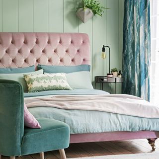 wall paneling with green coloured and pink bed
