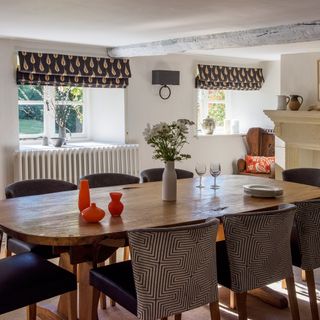 country dining room with orange and black textiles