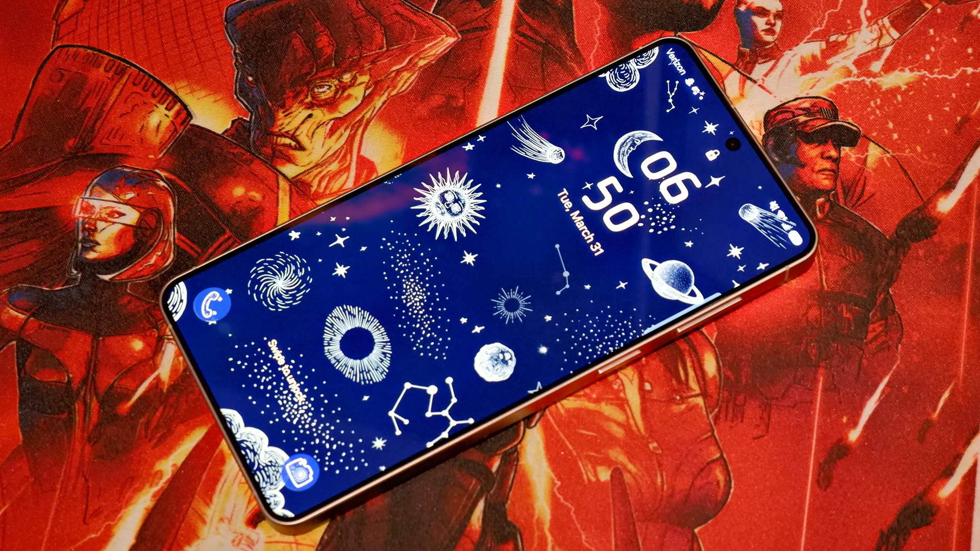 The Samsung Galaxy S26 Plus lock screen with stars and planets against a Mass Effect mouse pad.