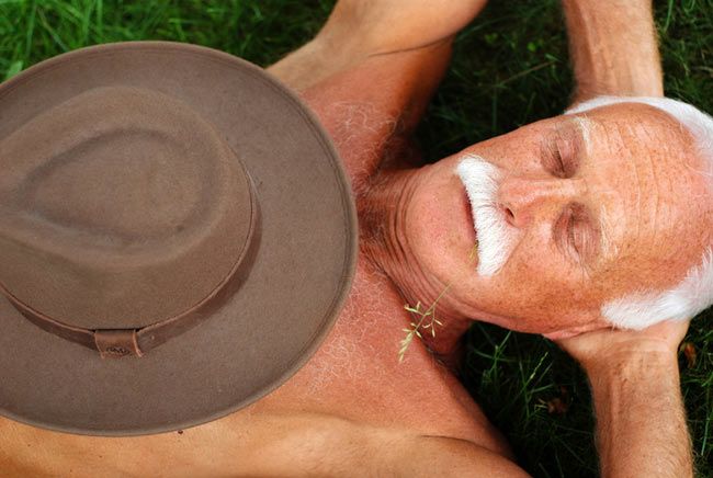 A man napping on the grass.