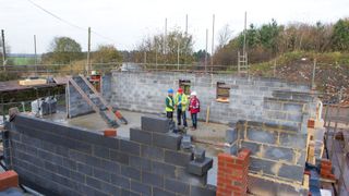 tradespeople standing on a build site
