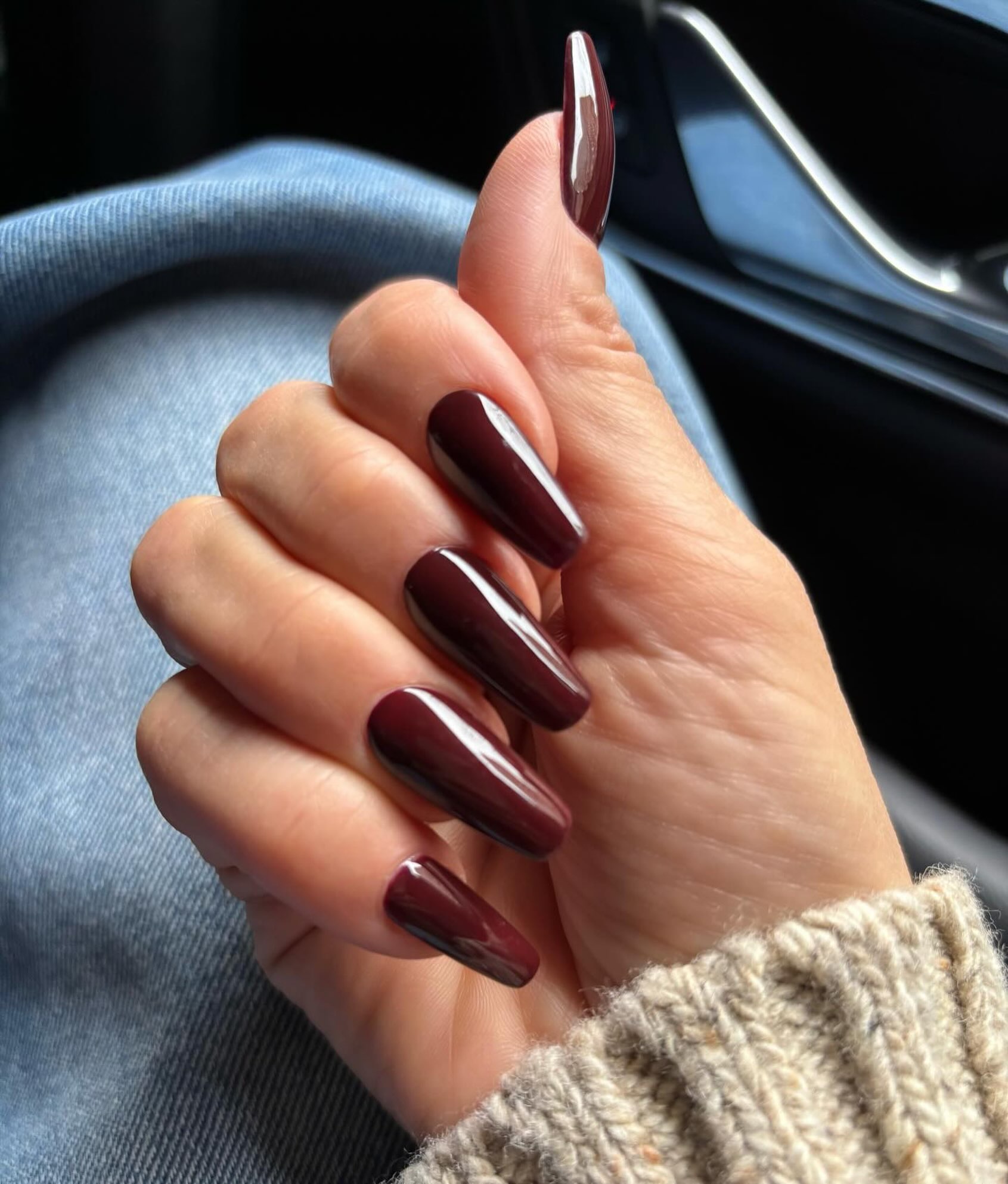 long coffin nails on J.Lo painted a glossy chocolate-cherry red