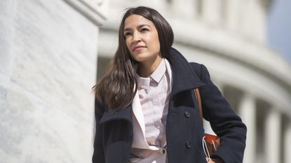 Rep. Alexandria Ocasio-Cortez, D-N.Y., is seen on the House steps of the Capitol before the House passed a $2 trillion coronavirus aid package by voice vote on Friday, March 27, 2020. 