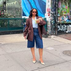 Influencer wearing a brown blazer, denim shorts, and pumps