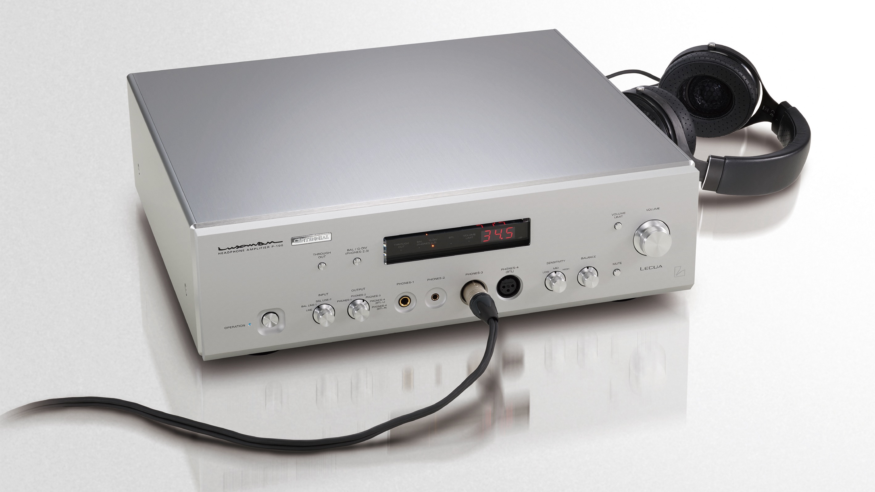 Luxman P-100 Centennial headphone amplifier in silver finish with a pair of headphones connected