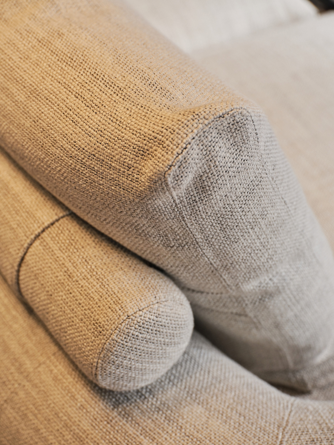 Close-up details of the Nathan Yong-designed sofa, from its softly curved upholstery and tailored seams to the refined proportions that give it an elevated contemporary feel.